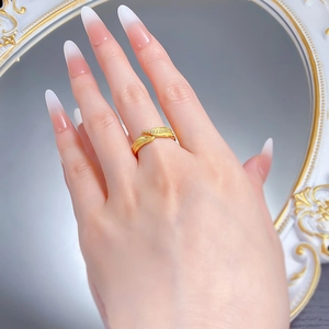Detailed close-up of a gold bypass leaf ring with diamonds on a model's hand