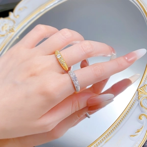 Detailed close-up of S925 silver and gold brushed rings with shimmering cubic zirconia stones