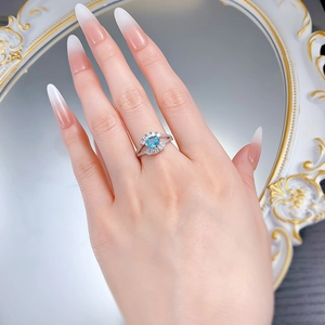 Close-up of an S925 silver ring with 5x7mm oval aquamarine gemstone on a model's finger