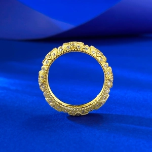 Macro detail of a gold clover ring with pavé-set diamonds and vintage baroque textures