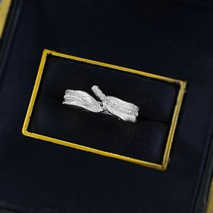 Detail of silver feather ring with zircons in a premium blue velvet jewelry gift box