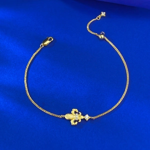 Elegant gold S925 silver fleur-de-lis bracelet with zirconia on blue textured background