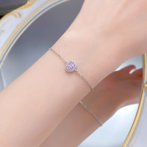 Detail of S925 silver bracelet featuring an oval pink gemstone with diamond halo