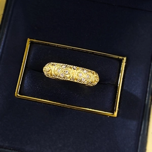 Vintage gold clover lantern ring with crystals displayed in a navy blue velvet jewelry box