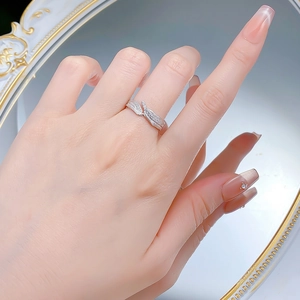 Close-up of a silver leaf ring with pavé diamonds and Italian brushed texture