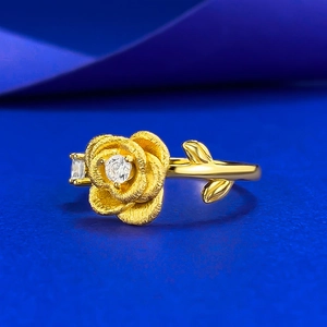 Elegant gold rose ring with brushed texture and sparkling zircon on dark blue background