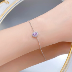 Detail of S925 silver bracelet with pink oval gemstone and sparkling diamond halo
