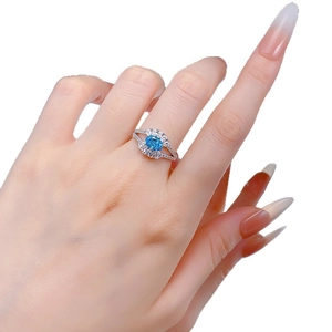 Elegant S925 silver ring featuring an oval blue aquamarine gemstone with zircon halo