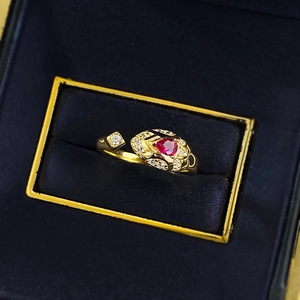 Detail of luxury snake ring with heart red gemstone and zircons in a premium blue velvet box