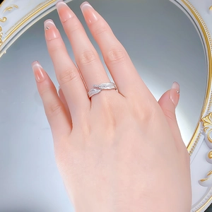 Detail view of a leaf shaped silver ring with Italian brushed finish and diamonds on finger