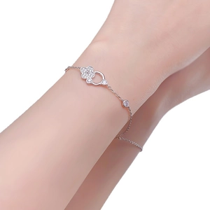 Elegant S925 silver four-leaf clover bracelet with pave diamonds on model wrist