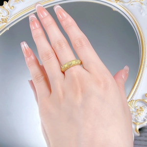 Detailed view of vintage gold ring with clover lantern pattern and sparkling zircons