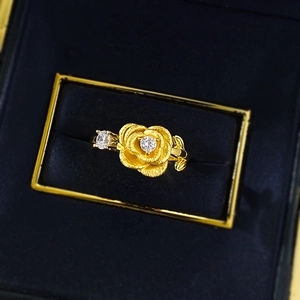 Macro shot of brushed gold rose ring featuring a sparkling central diamond detail