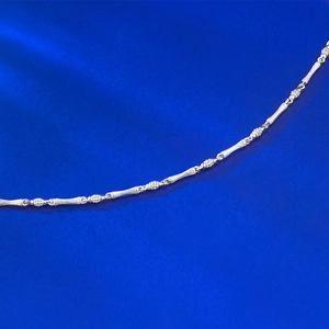 Macro detail of S925 sterling silver bamboo style chain with a brushed vintage texture