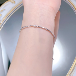 Detail view of S925 sterling silver bamboo joint bracelet worn on wrist with gold mirror