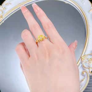 Close-up of golden rose ring with sparkling diamonds on a vintage mirror background