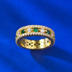 Macro detail of S925 sterling silver stamp on rose gold ring with green and white gems