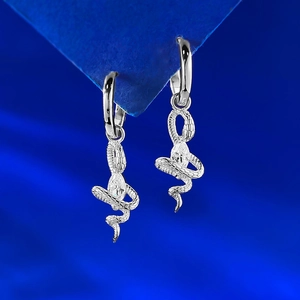 S925 silver snake earrings with marquise-cut diamond on royal blue background