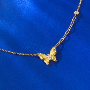 Gold butterfly pendant necklace with matte texture and asymmetric chain design
