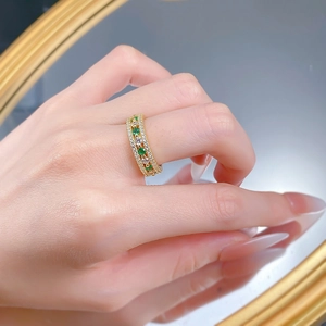 Detailed shot of an S925 silver ring with rose gold plating and green gemstones