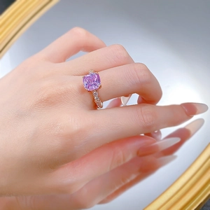 Close-up of lavender purple cushion cut gemstone ring with rose gold bamboo band detail