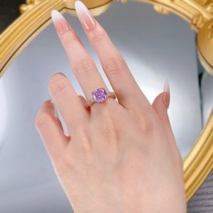 Detail of cushion-cut lavender zircon ring with micro-pave diamonds on rose gold band