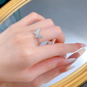 Detail of S925 silver butterfly ring with sparkling zircon wings and rope twist band