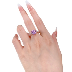 Elegant rose gold ring with a large purple rectangular gemstone and pavé diamonds
