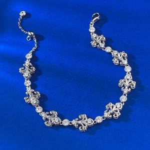 S925 sterling silver fleur-de-lis bracelet with sparkling cubic zirconia on blue silk