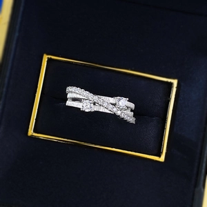 Three-layer crisscross S925 silver ring featuring brushed finish and sparkling cubic zirconia