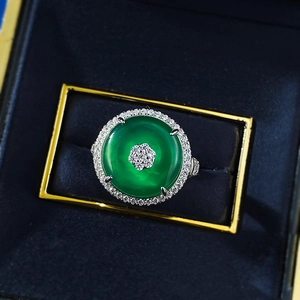 Macro view of S925 silver ring featuring green chalcedony and floral diamond pavé detail