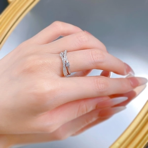 Macro view of triple-layered S925 silver ring featuring crossing lines and sparkling crystals