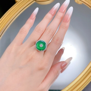Macro detail of S925 silver ring featuring a round green chalcedony and diamond halo
