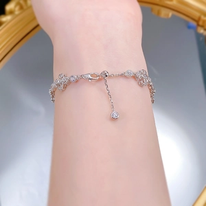 Close-up of S925 sterling silver iris bracelet with floral hollow design and zircon charm