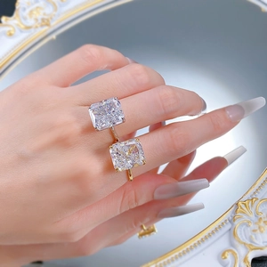 Macro detail of square cut rings with four-prong settings on a vintage tray