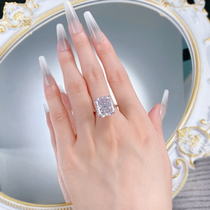 Close-up of radiant cut ice flower sparkling stone ring on finger with silver band
