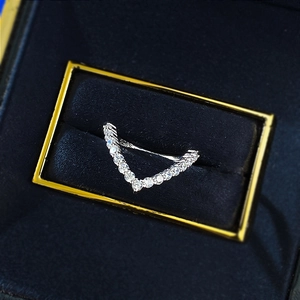Macro detail of S925 sterling silver V-shaped ring with pave zircons in a gift box