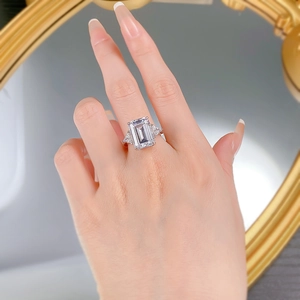 Detail of emerald cut s925 silver ring on hand with elegant triangular side stones