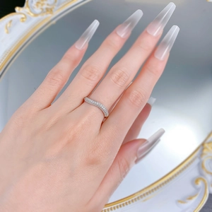 Macro detail of V-shaped wavy band ring with sparkling pavé-set round cubic zirconia