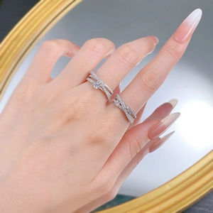 Close-up of S925 sterling silver triple-layered pavé rings with a modern crossover design