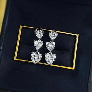 Sparkling S925 sterling silver earrings featuring three graduated heart-shaped crystals