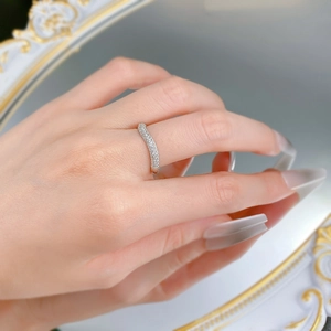 Close-up of elegant S925 silver wave ring with micro-pave diamonds on model's finger
