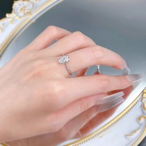 Macro shot of 925 silver ring with 6x9mm oval cut stone and pave diamond band detail