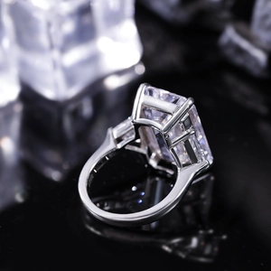 Close-up of S925 sterling silver ring with large emerald-cut stone on an ice background