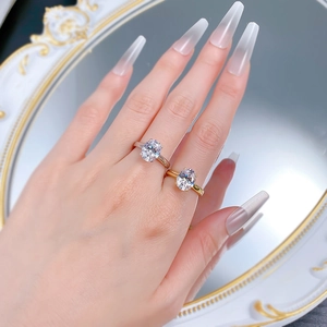 Detail of gold and silver S925 rings with 4-carat oval cut stones worn by model