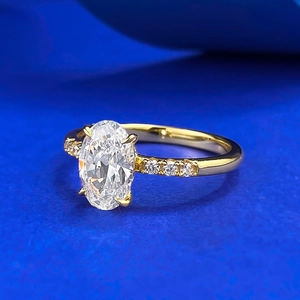 Elegant 18K gold ring with large oval-cut gemstone and pave-set side diamonds