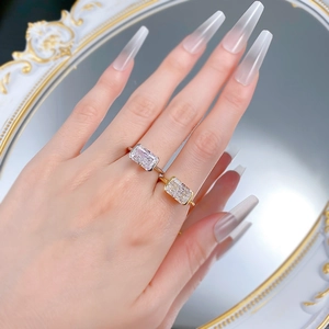 Detail of gold and silver rectangle ice-cut rings shown on a vintage mirror background