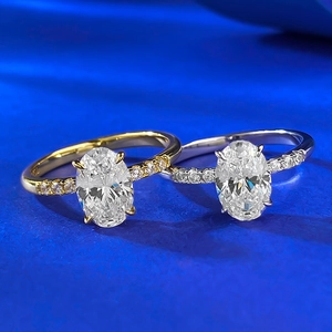 Close-up of dual-tone S925 silver rings with large oval-cut stones and pavé diamonds