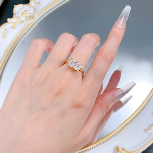Detail shot of rectangular ice flower cut gemstone set in a minimalist gold-plated ring band
