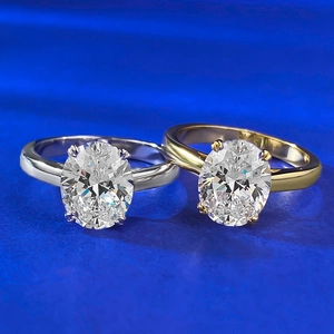 Macro shot of two oval cut 4 carat gemstones in classic four-claw silver and gold settings